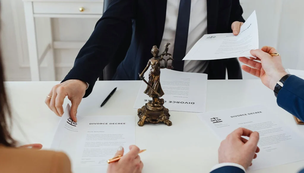 shot of attorney from the chest down handing papers to a client