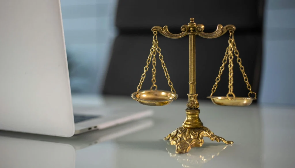 empty desk and chair with the lawyer scale statue