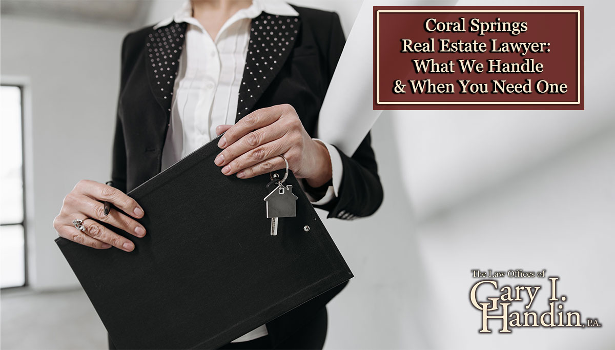 Close-up of a realtor holding a keychain and clipboard with interior office background.