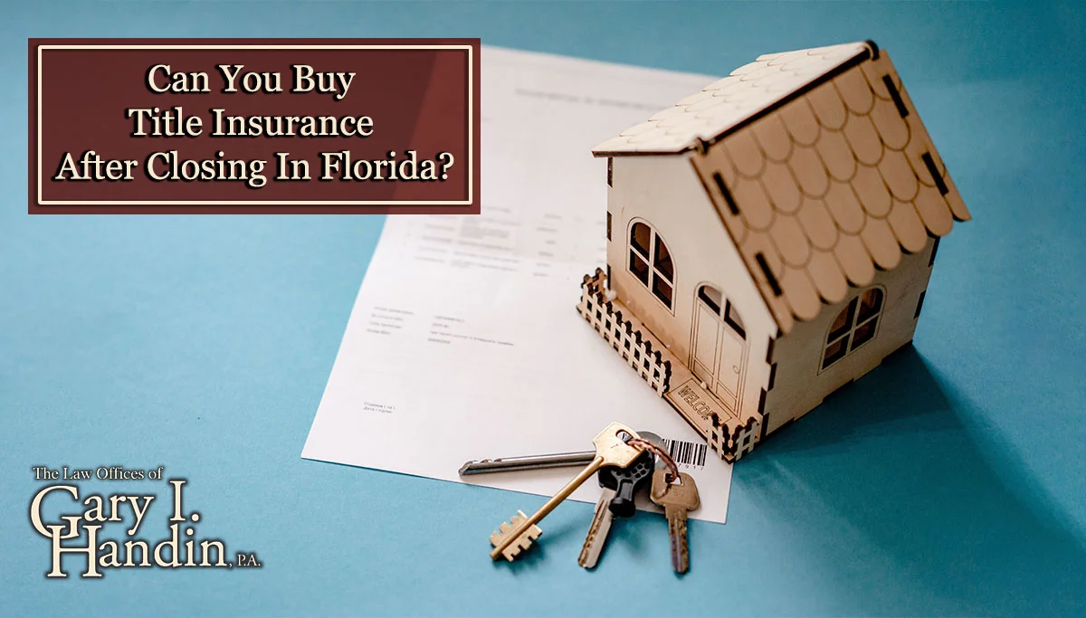 Miniature wooden house with keys and contract.