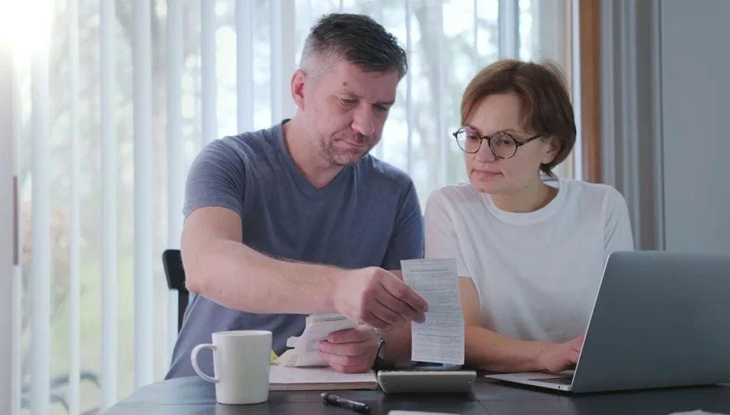 woman-and-man-together-checking-bills-taxes
