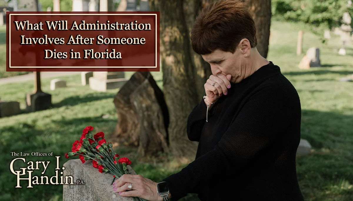 older woman rests roses on a tombstone while in a cemetary